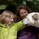 A woman and a young girl petting a sled dog